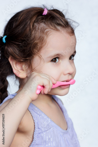 Adorable child girl cleanin...