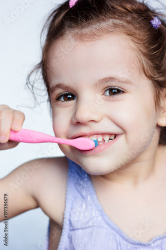 Adorable child girl cleanin...