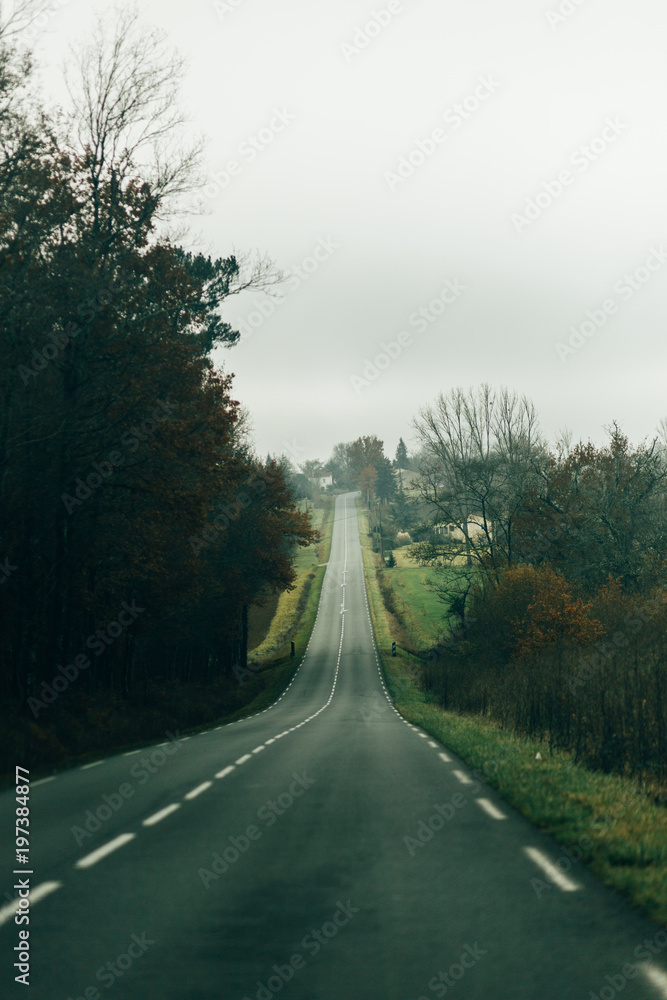 Asphalt road passing through countryside