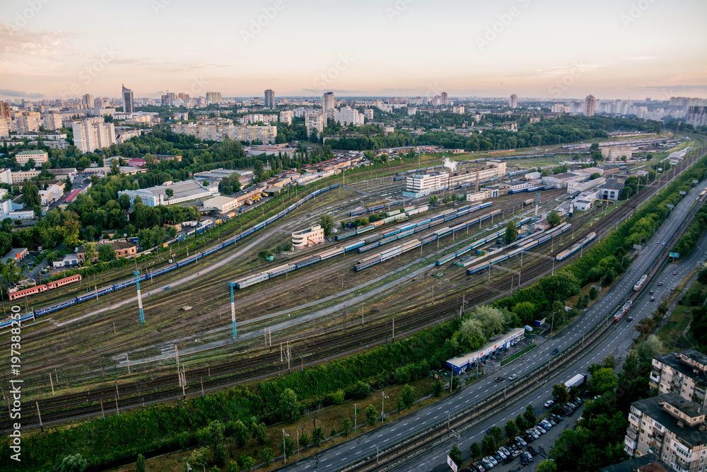 Railway tracks and colorful wagons, top view, aerial shoot, view from above, green