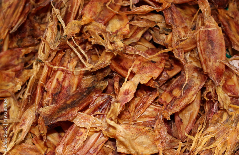 Dried squid on street seafood market in the thailand for background. On dried squid sit flies. Selective focus Dried squid on street seafood market in the thailand for background. On dried squid sit flies. Selective focus
