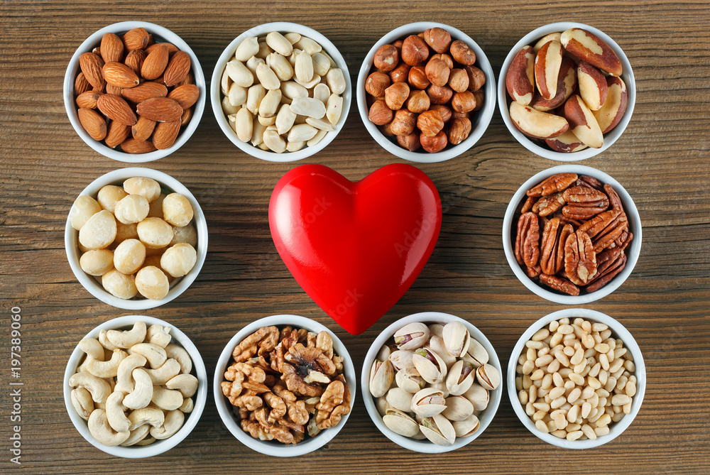 Fototapeta premium Different types of nuts in small bowls