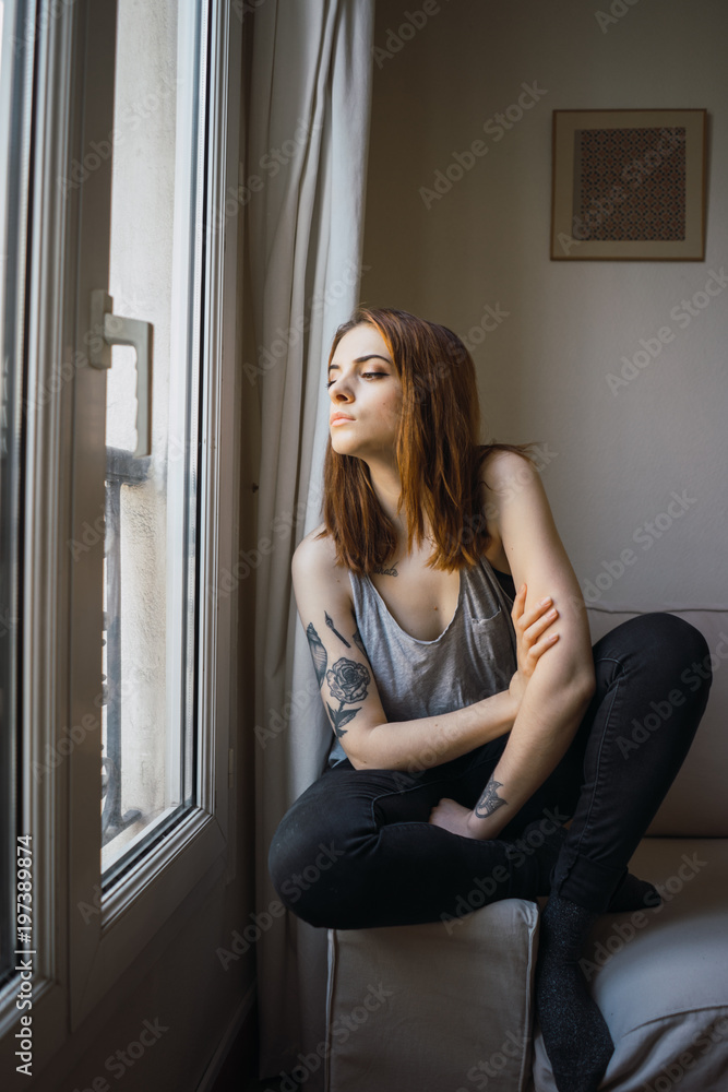 Pretty sensual tattooed woman at window Pretty sensual tattooed woman at window