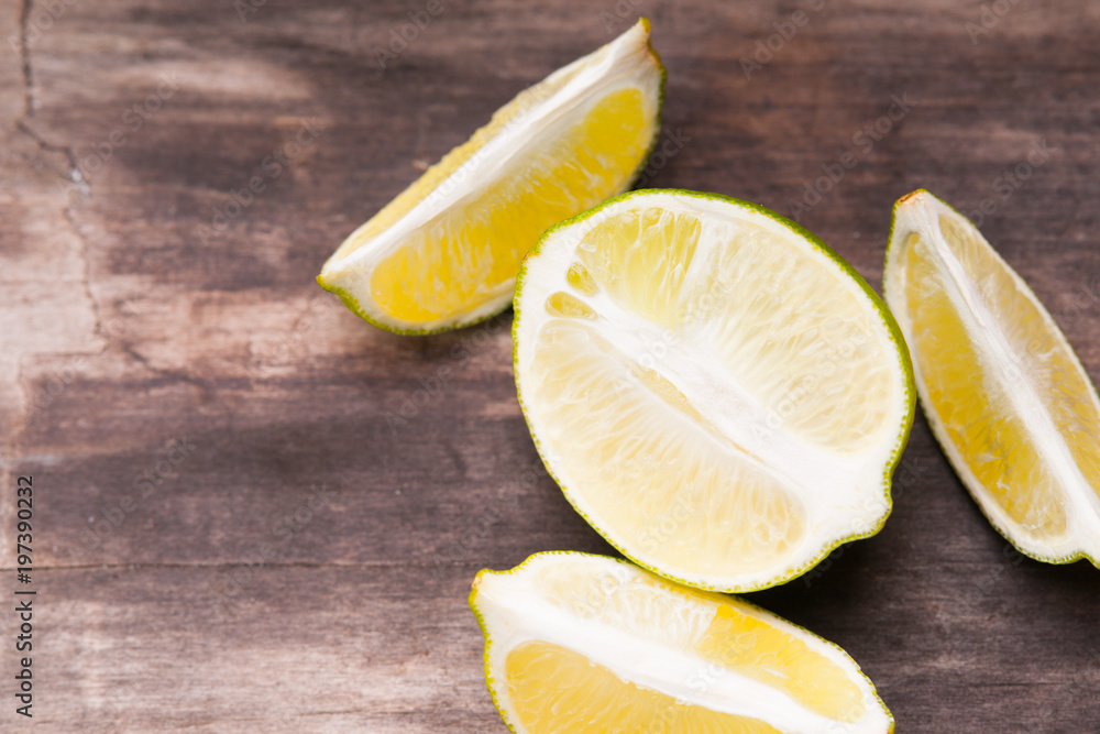 Slices of lime on wooden background Slices of lime on wooden background