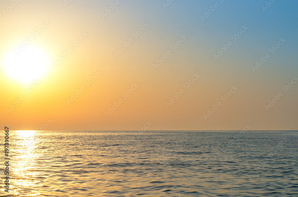 sunrise over the sea horizon, reflections on the water, waves