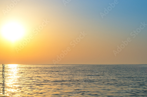sunrise over the sea horizon, reflections on the water, waves