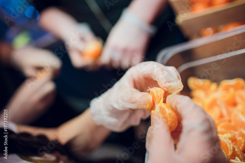 To clean tangerine. To remove a peel from tangerine. Cleaning of a madarin of a peel. photo