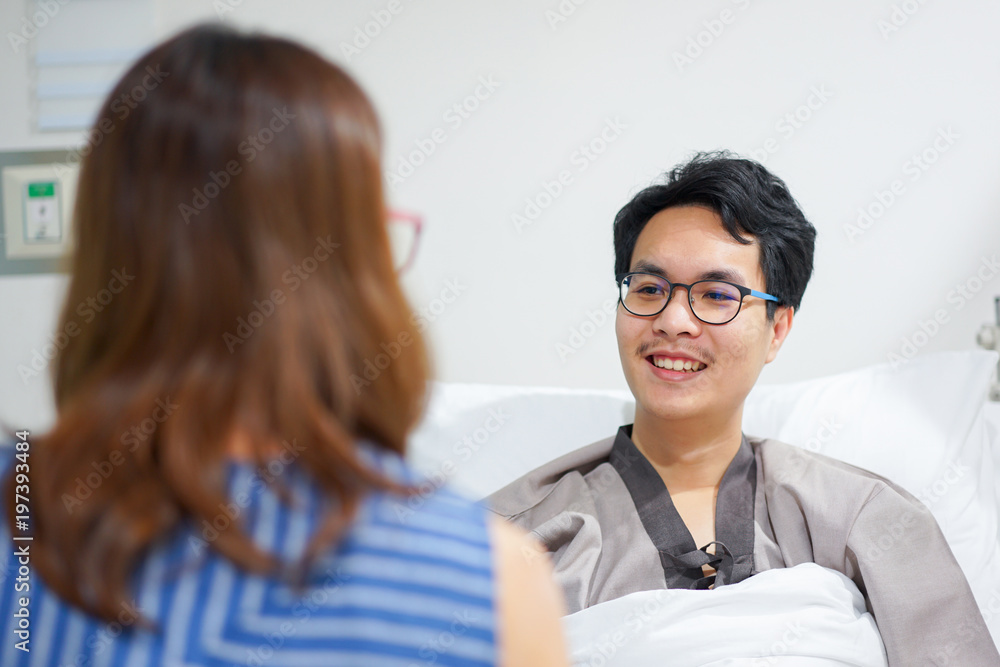 close up patient man talking with his wife after get well from disease in medical room at hospital concept close up patient man talking with his wife after get well from disease in medical room at hospital concept