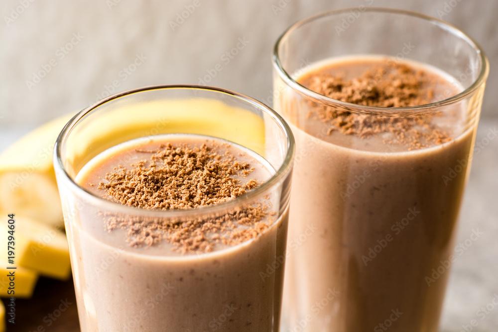 Chocolate banana smoothie in glass on gray stone background Chocolate banana smoothie in glass on gray stone background