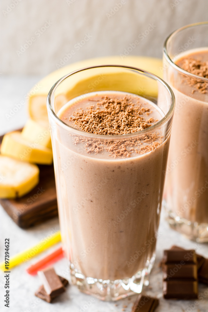 Chocolate banana smoothie in glass on gray stone background Chocolate banana smoothie in glass on gray stone background