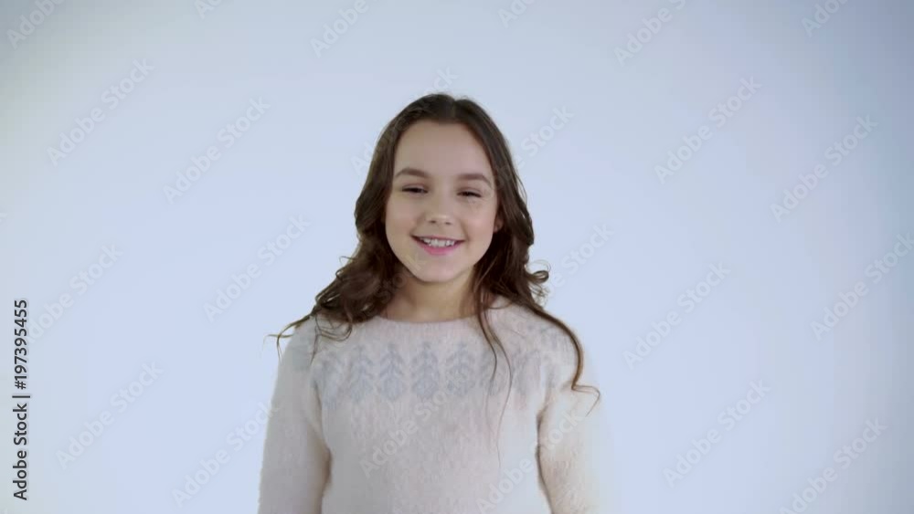 Portrait of smiling and cheerful girl looks at camera on white background Portrait of smiling and cheerful girl looks at camera on white background