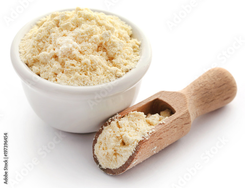 Gram flour in bowl and wooden scoop