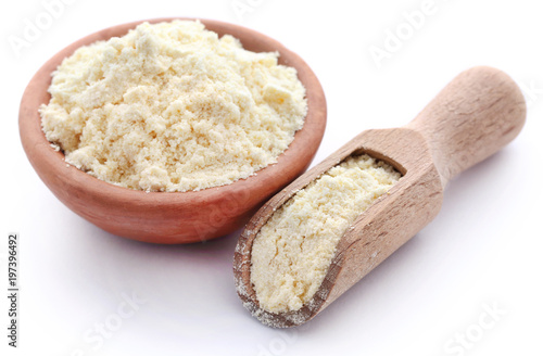 Gram flour in bowl and wooden scoop