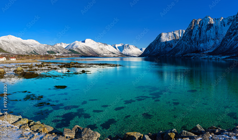Panoramic view of beautiful winter lake with snowy mountains at Lofoten Islands in Northern Norway