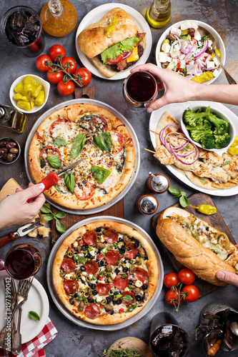 Big dinner with pizza and sandwiches