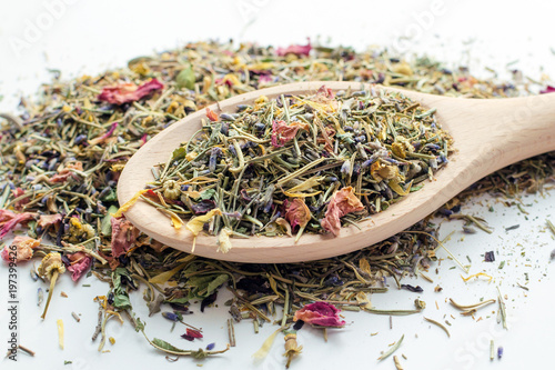 dry mountain herbal tea in big wooden spoon