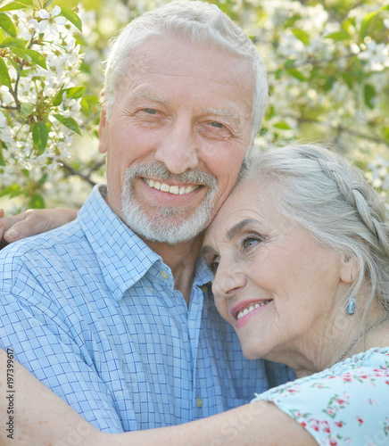 couple hugging in blooming garden