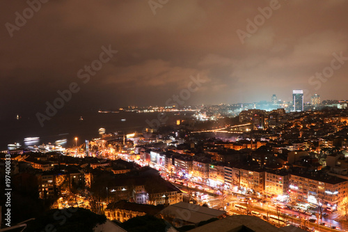 high angle view of illuminated cityscape against sky at night  © halilcan