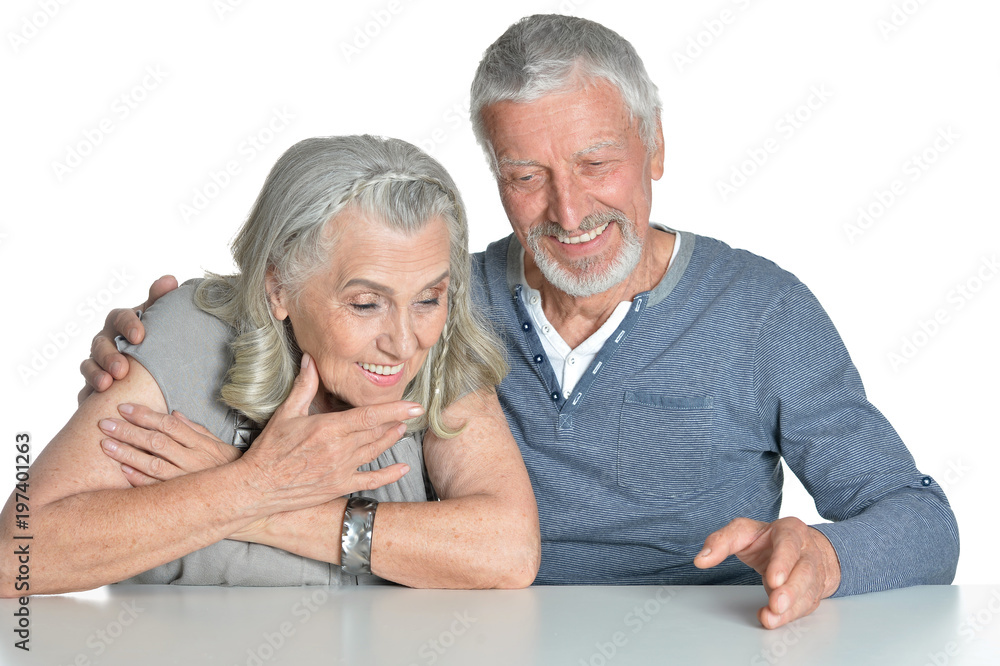 Portrait of hugging senior couple sitting at table Portrait of hugging senior couple sitting at table