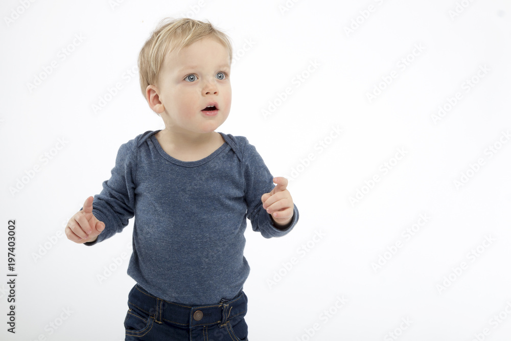 thoughtful and surpised toddler on the white background. copy space. studio shot