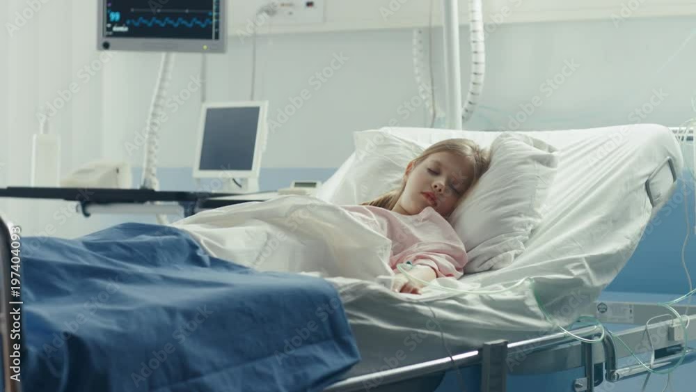 Cute Little Sick Girl Sleeps on a Bed in the Children's Hospital. Modern Pediatric Ward with Top Quality Health Care. Shot on RED EPIC-W 8K Helium Cinema Camera. Cute Little Sick Girl Sleeps on a Bed in the Children's Hospital. Modern Pediatric Ward with Top Quality Health Care. Shot on RED EPIC-W 8K Helium Cinema Camera.