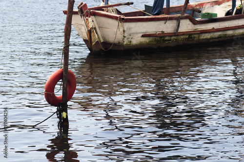 Buoy Saves Lives and Fishing and tourism boat docked on the pier in various sizes and colors on the coast of São Paulo