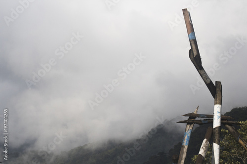 A nature landscape of a large green mountain, with fog flying behind them, a peaceful and steep place to visit not coastal Sao Paulo.