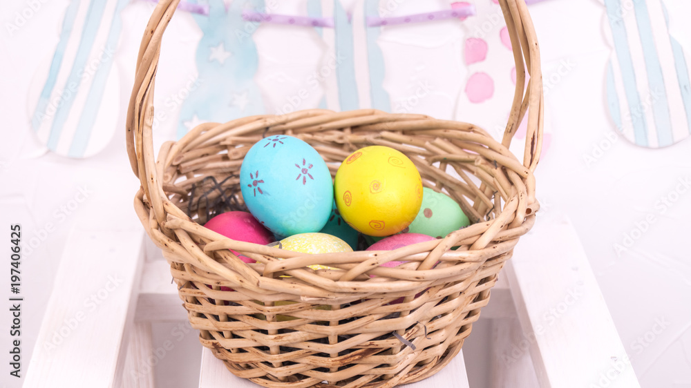 Easter decorations: basket with Easter eggs on a white background