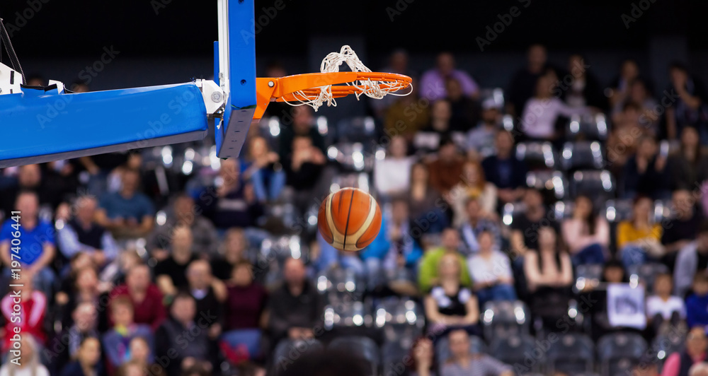 Fototapeta premium scoring during basketball game - ball going through hoop