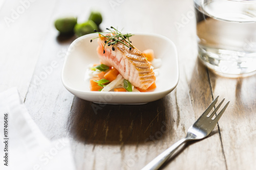 fresh little salad with salmon and sprouts on wooden table