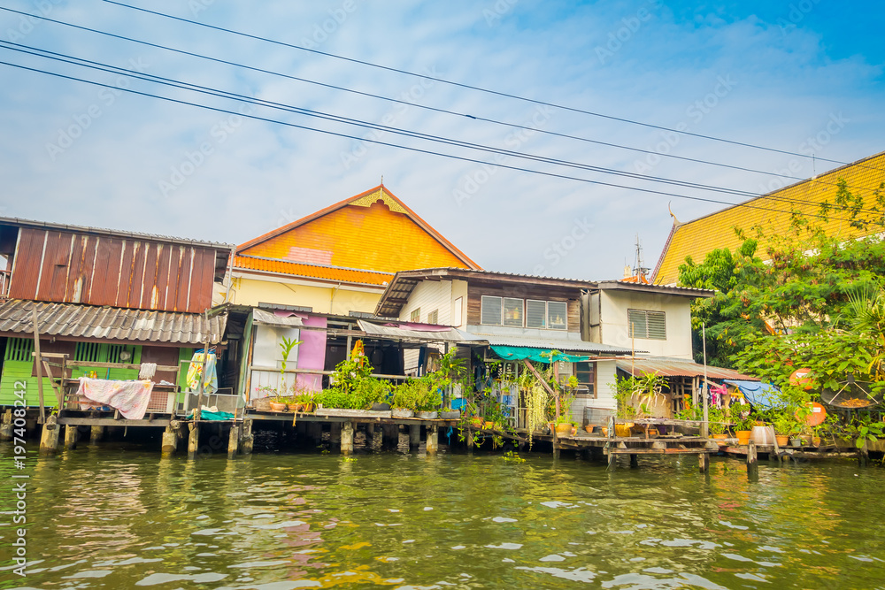 Outdoor view of floating wooden poor house located on the Chao Phraya river. Thailand, Bangkok