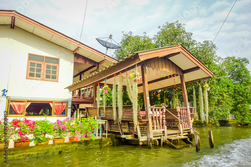 Outdoor view of gorgeous floating wooden house on the Chao Phraya river. Thailand, Bangkok