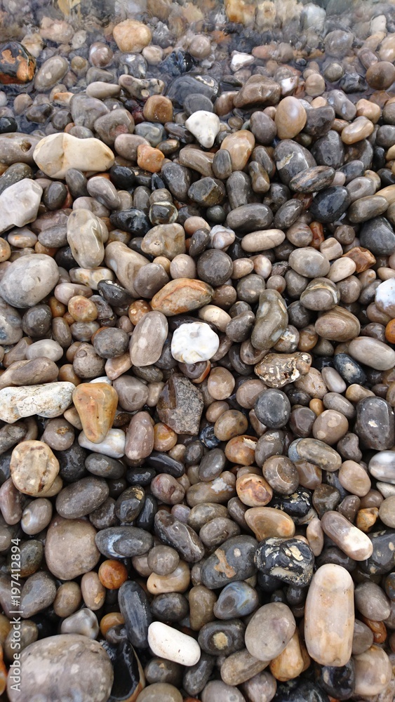 wave washing over pebbles wave washing over pebbles