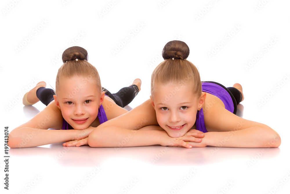Girls gymnasts perform exercises. Girls gymnasts perform exercises.