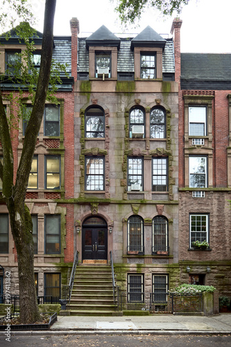 A tall brownstone building in an iconic neighborhood of Manhattan, New York