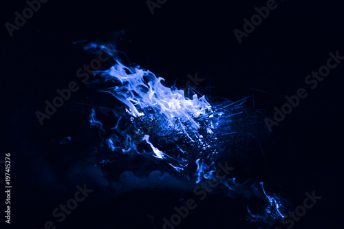 Blue flame. Burning of rice straw at night.