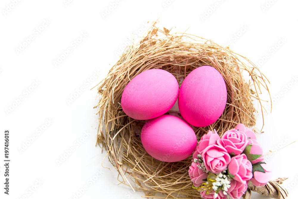 Pink colored Easter eggs in nest on wooden background, selective focus image. Happy Easter card Pink colored Easter eggs in nest on wooden background, selective focus image. Happy Easter card