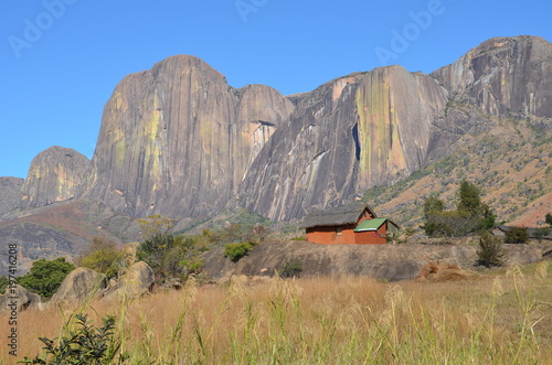 Lone Adobe House looking Lost against the Sheer Walls of the Magnificent Tsaranoro Massif, Madagascar photo