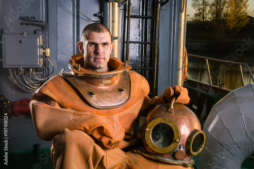 the brave diver sits on the deck of the ship