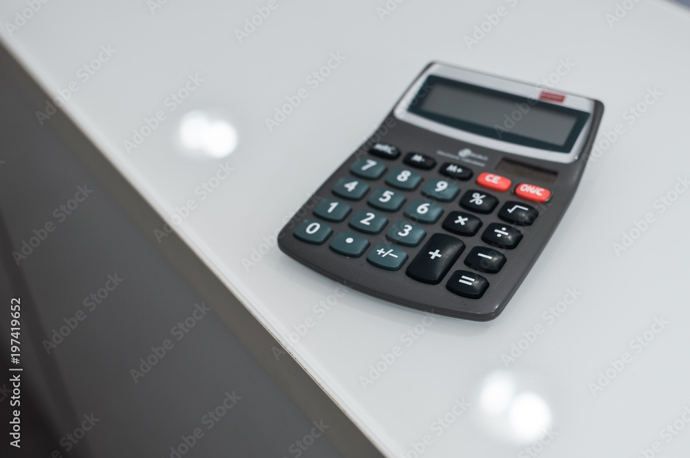 Closeup on calculator over light desk background. Top side view flat lay style of digital compute technology idea Closeup on calculator over light desk background. Top side view flat lay style of digital compute technology idea