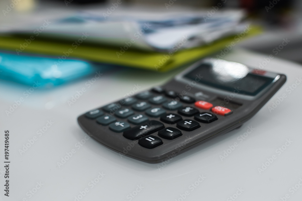Closeup on calculator over light desk background. Top side view flat lay style of digital compute technology idea Closeup on calculator over light desk background. Top side view flat lay style of digital compute technology idea