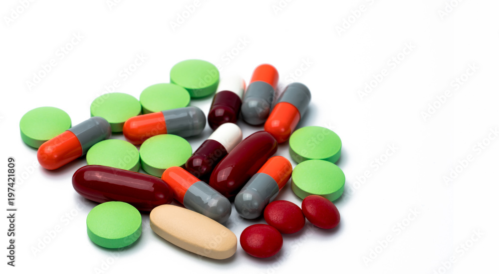 Pile of colorful tablets and capsule pills isolated on white background. Drug, vitamin, supplement and herbal medicine interactions . Drug use in pregnancy woman. Drug safety and healthcare concept Pile of colorful tablets and capsule pills isolated on white background. Drug, vitamin, supplement and herbal medicine interactions . Drug use in pregnancy woman. Drug safety and healthcare concept