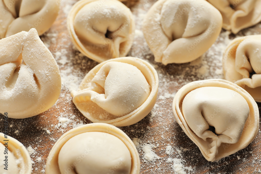 Raw dumplings on wooden background, closeup Raw dumplings on wooden background, closeup