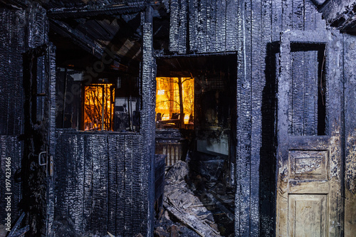 Burnt house. Burned furniture, door, charred walls and ceiling