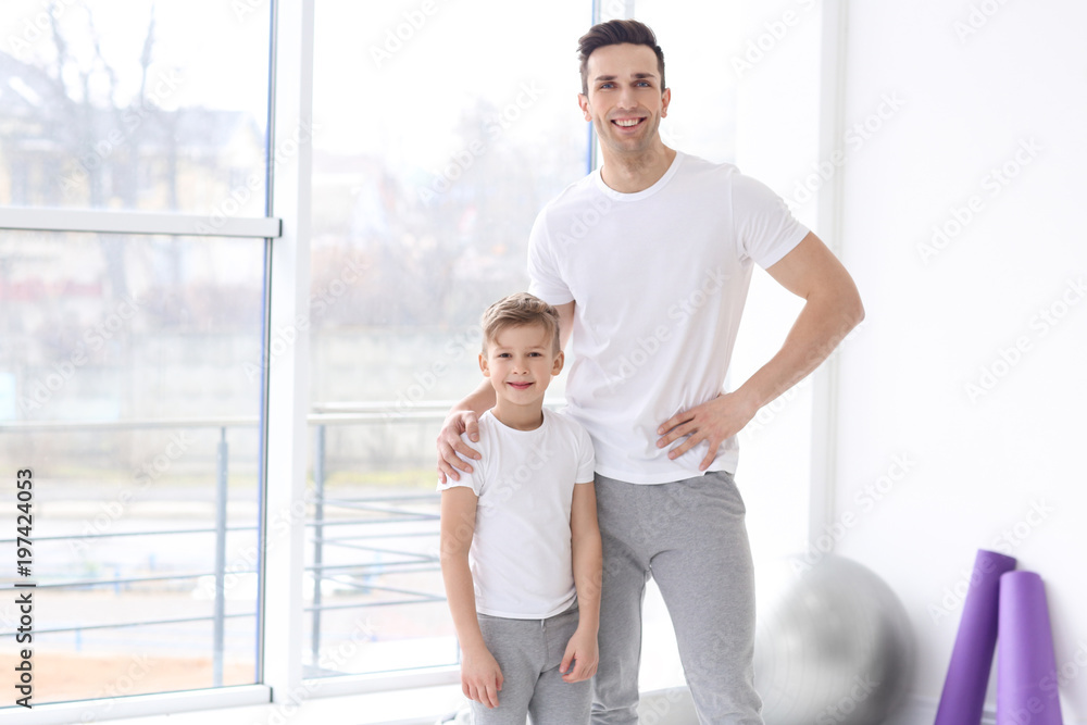 Fototapeta premium Dad and his son in gym