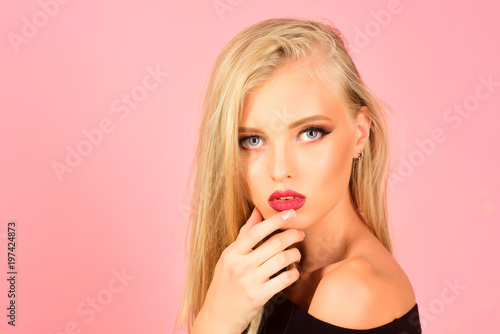 Skincare, haircare, beauty, fashion concept - glamour gorgeous blonde lady with straight long hair and beautiful makeup. Isolated on pink background. Beautiful spa model girl. Perfect fresh clean skin