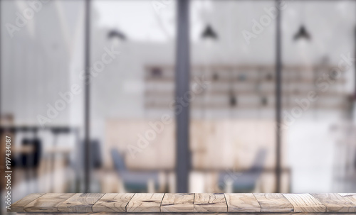 Wooden top table with white blurred cafe interior Background