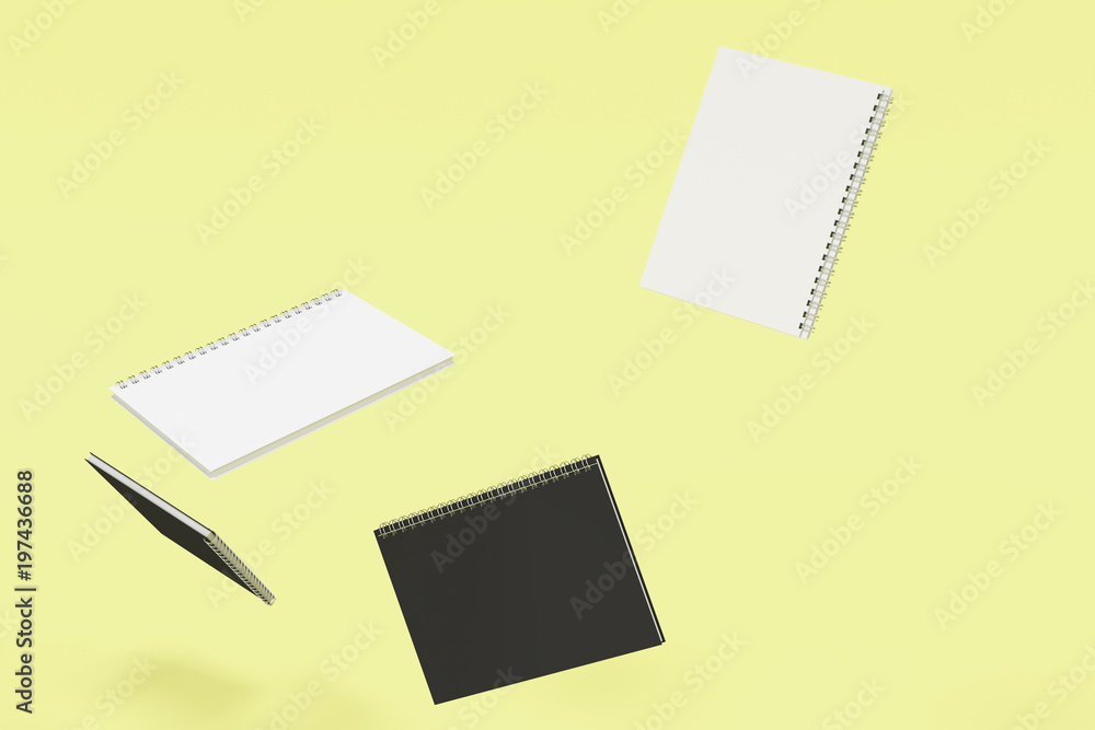 Four notebooks with spiral bound on yellow background Four notebooks with spiral bound on yellow background