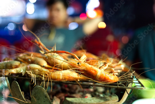 Seafood buffet concept. shrimp and crab grilled on stove, soft focus.