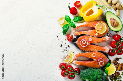 Raw fresh salmon steak with vegetables. Ingredients for cooking on white background. Space for text. Diet and healthy food concept. Banner